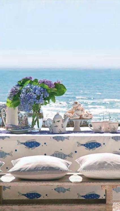 coastal-dining-space-set-with-a-view-and-spring-flowers